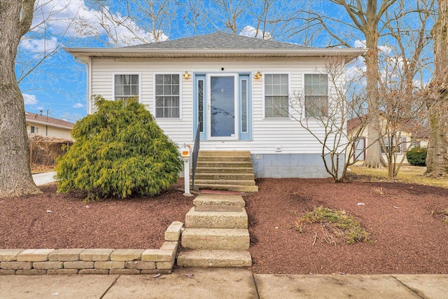 bungalow with a shingled roof and entry steps