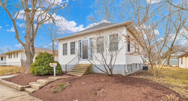 bungalow-style house featuring fence and cooling unit