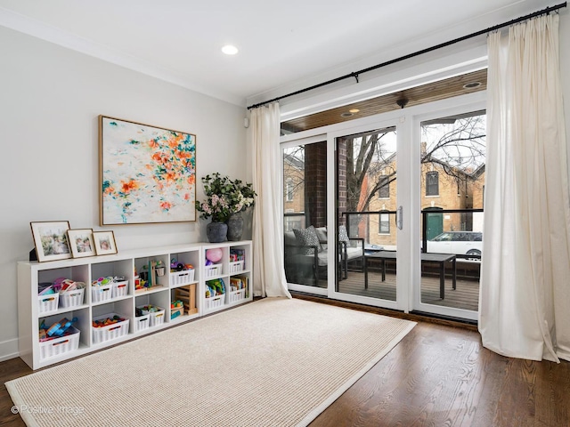 recreation room featuring a healthy amount of sunlight, crown molding, wood finished floors, and recessed lighting