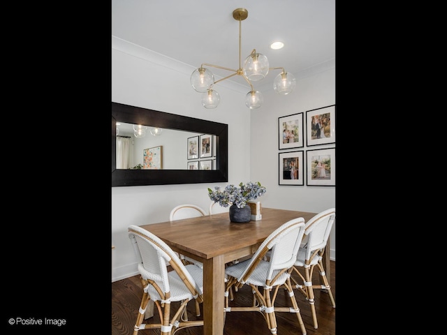 dining space featuring baseboards, ornamental molding, and wood finished floors