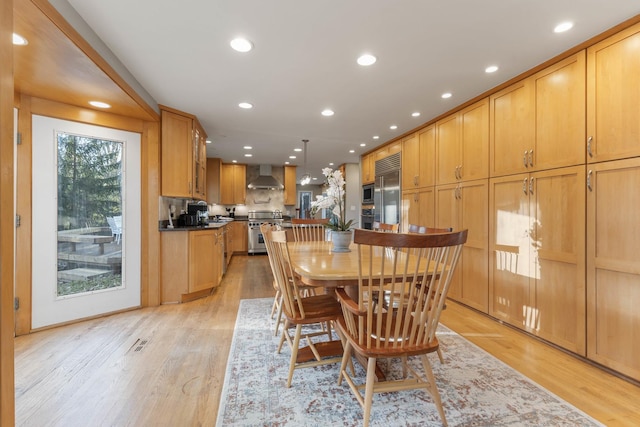 dining space with light wood-type flooring and recessed lighting