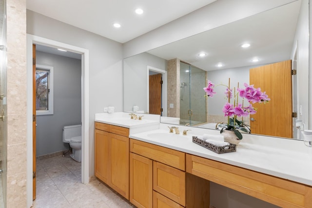 bathroom featuring tile patterned flooring, toilet, recessed lighting, vanity, and a shower stall