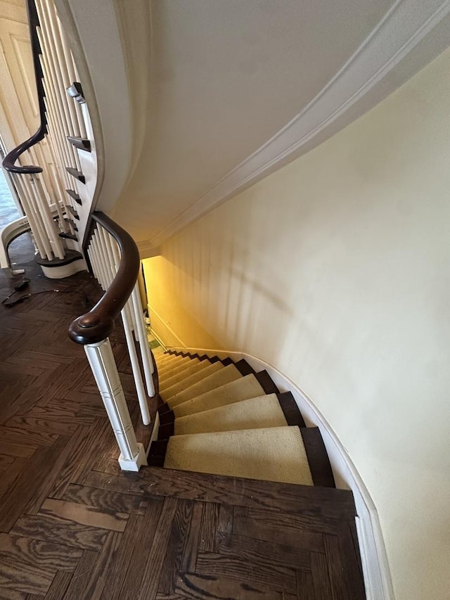 stairway featuring ornamental molding