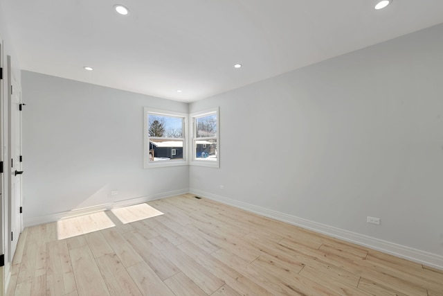 unfurnished room with baseboards, light wood-type flooring, and recessed lighting