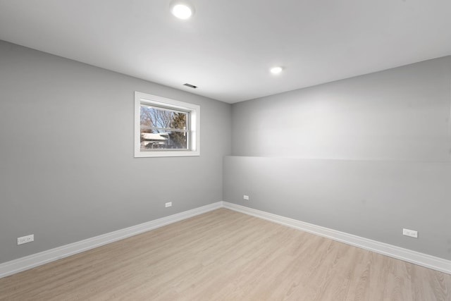 empty room with light wood-type flooring and baseboards