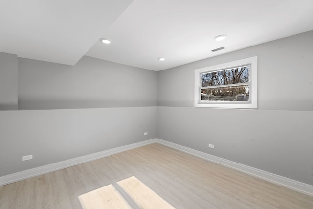 spare room with recessed lighting, visible vents, light wood finished floors, and baseboards