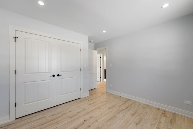 unfurnished bedroom with light wood-type flooring, baseboards, and recessed lighting