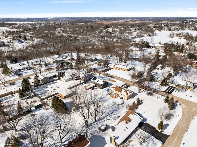 snowy aerial view with a residential view