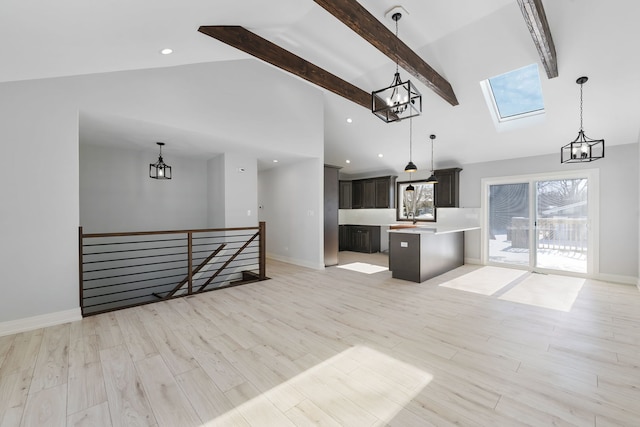 kitchen with open floor plan, light countertops, and hanging light fixtures