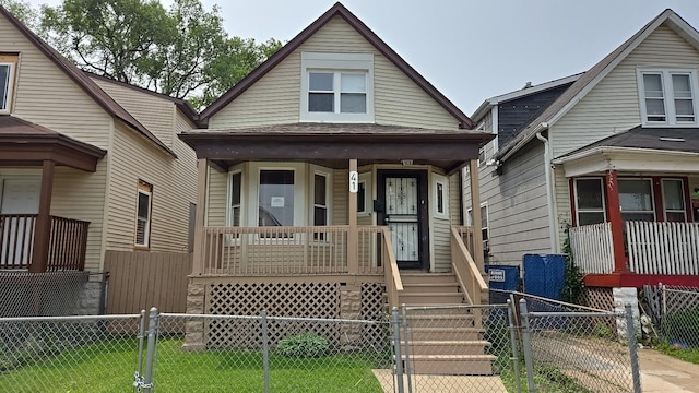 41 E 100th Pl, Chicago, IL 60628 - view of front of home featuring a porch, a gate, and a fenced front yard