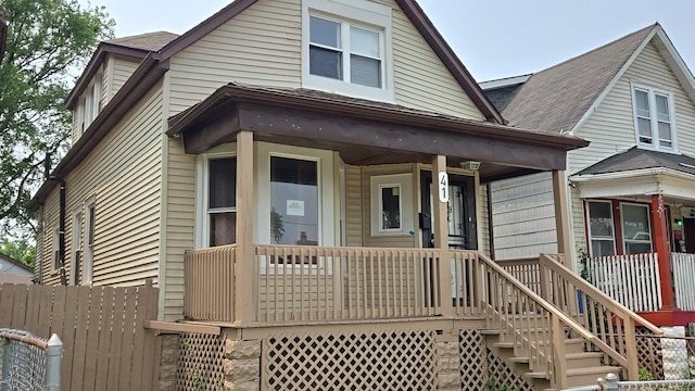 41 E 100th Pl, Chicago, IL 60628 - view of front facade with a porch, stairs, and roof with shingles
