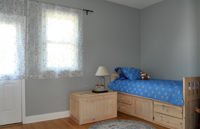 unfurnished bedroom featuring light wood-style flooring and baseboards