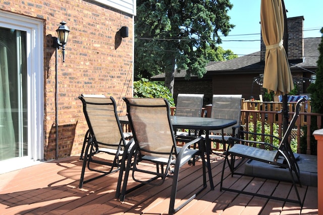 deck with outdoor dining area