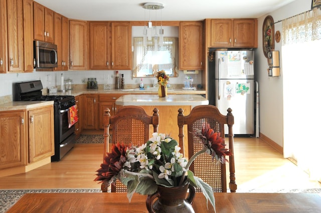 kitchen with brown cabinets, stainless steel appliances, and light countertops