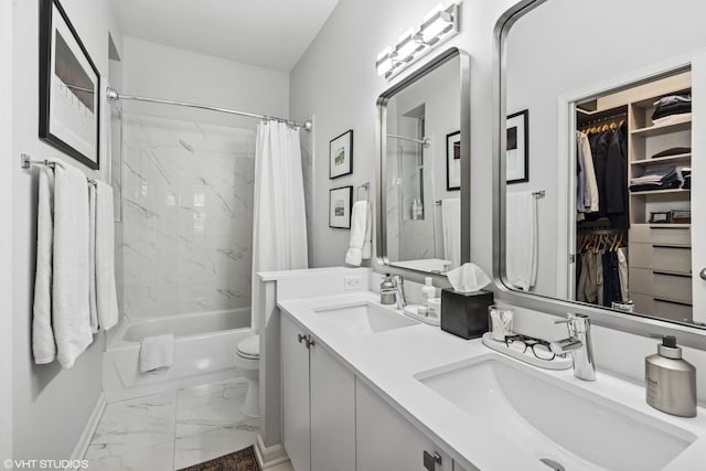 bathroom with double vanity, marble finish floor, shower / bath combo with shower curtain, and a sink