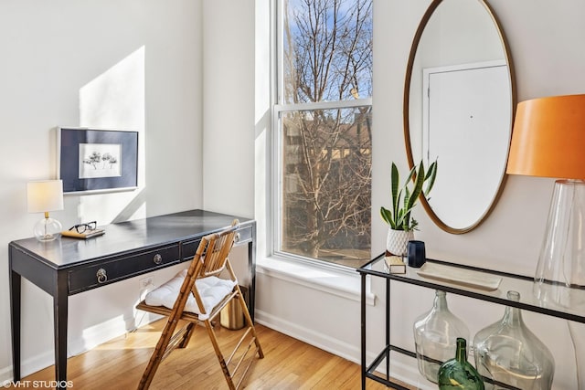 office with light wood-type flooring and baseboards