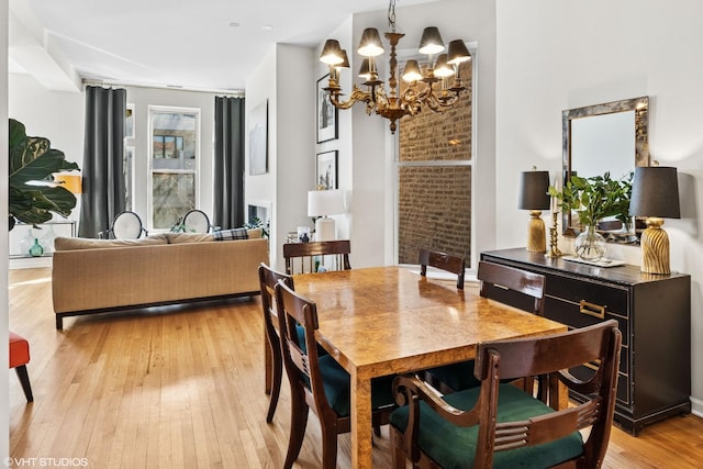 dining space featuring a chandelier and light wood-style floors