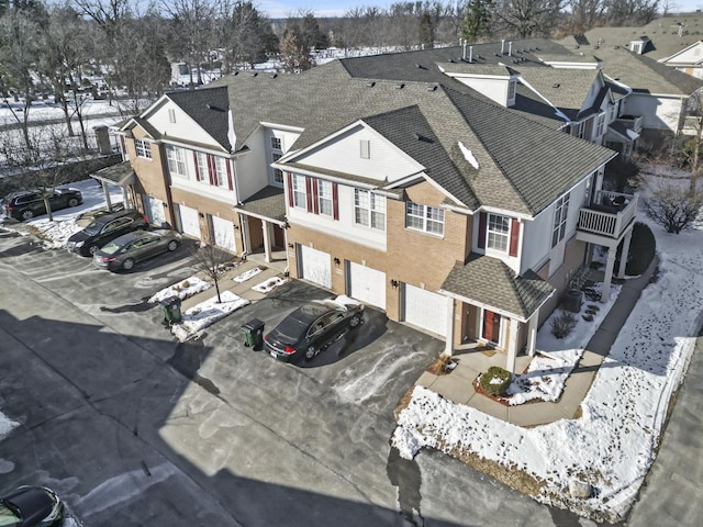 snowy aerial view with a residential view