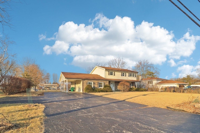 view of front of home featuring aphalt driveway and a carport