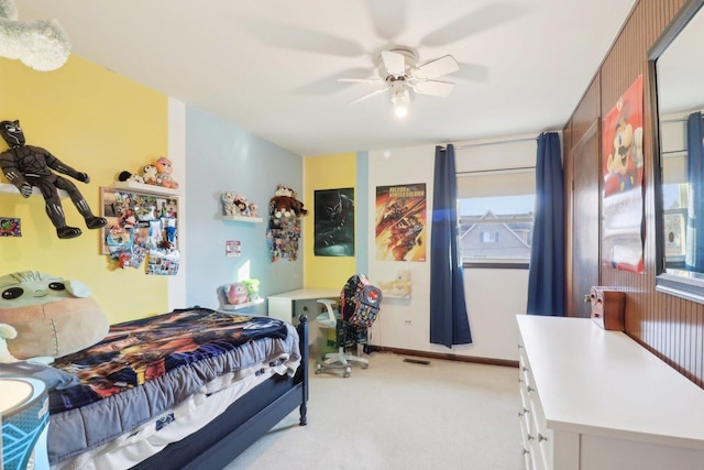 bedroom featuring baseboards, visible vents, a ceiling fan, and light colored carpet