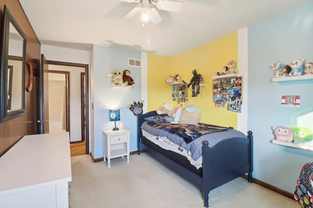 carpeted bedroom with a ceiling fan, visible vents, and baseboards