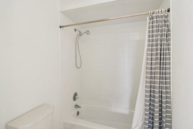 bathroom with shower / bath combo and toilet