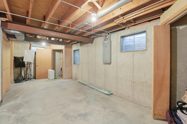 unfinished basement featuring electric panel