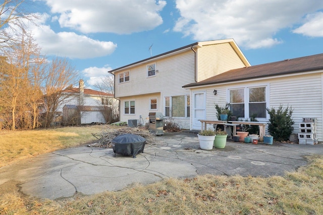 rear view of house with a patio, a lawn, and central air condition unit