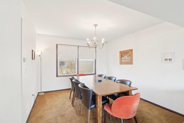 dining space with a chandelier, light colored carpet, and baseboards