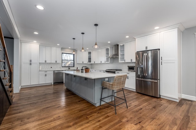 kitchen with glass insert cabinets, white cabinetry, appliances with stainless steel finishes, and light countertops