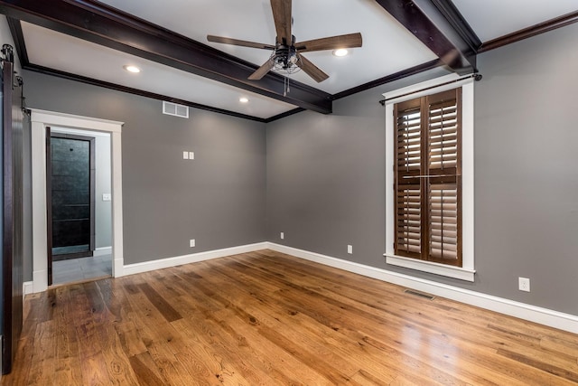 empty room featuring ornamental molding, beam ceiling, visible vents, and baseboards