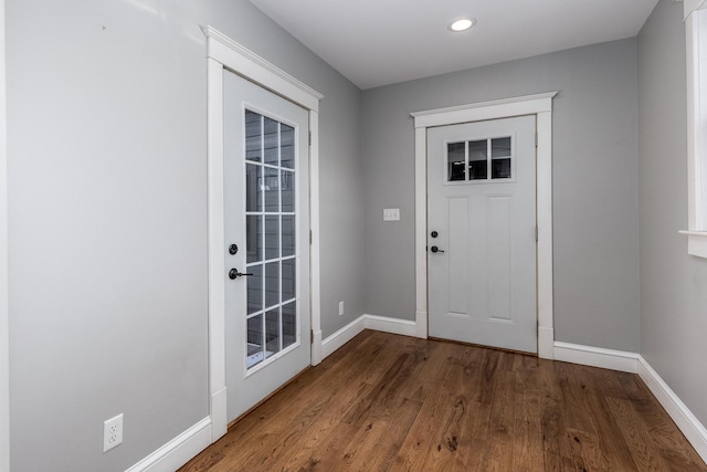 doorway featuring dark wood-type flooring, recessed lighting, and baseboards