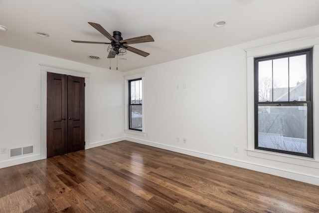 spare room featuring recessed lighting, visible vents, baseboards, and wood finished floors