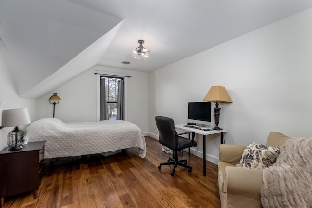 bedroom featuring vaulted ceiling, dark wood-type flooring, visible vents, and baseboards