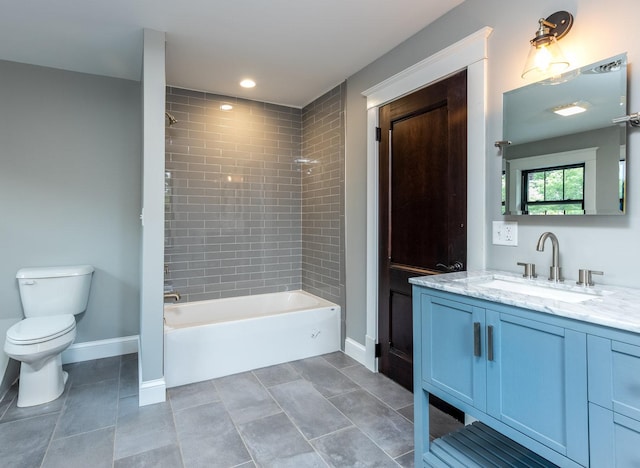 bathroom featuring baseboards, toilet, tile patterned floors, bathtub / shower combination, and vanity