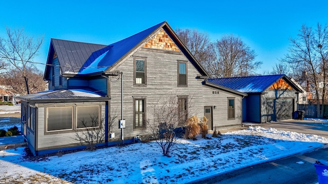 exterior space featuring driveway and metal roof