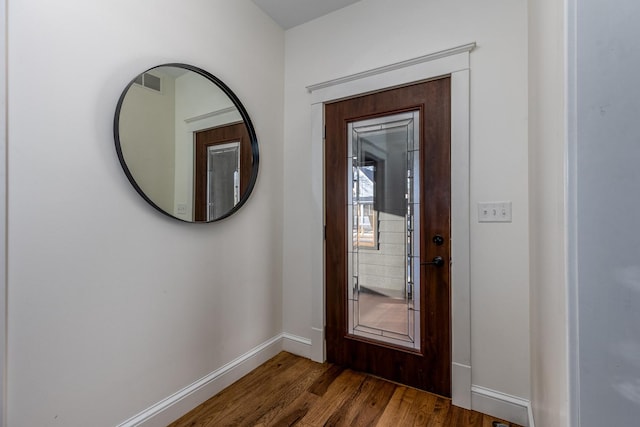 entrance foyer with visible vents, baseboards, and dark wood-type flooring