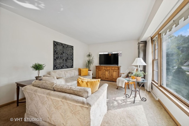 living room featuring light carpet and baseboards