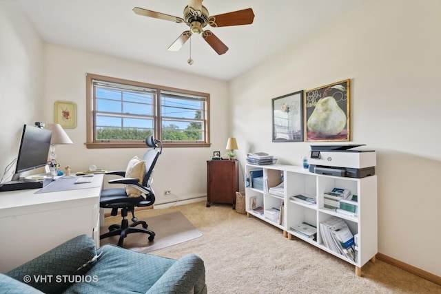 office space with a ceiling fan, baseboard heating, light colored carpet, and baseboards