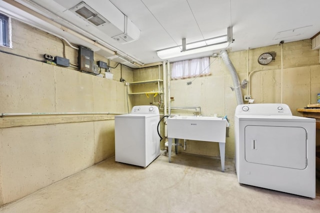 washroom featuring laundry area, a sink, and washer and dryer