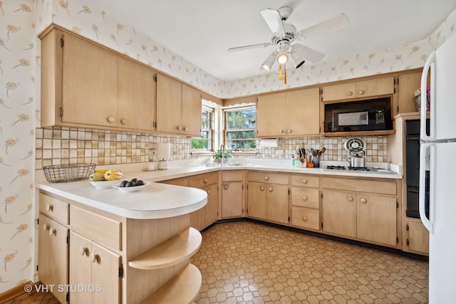 kitchen featuring open shelves, a sink, light countertops, black appliances, and wallpapered walls