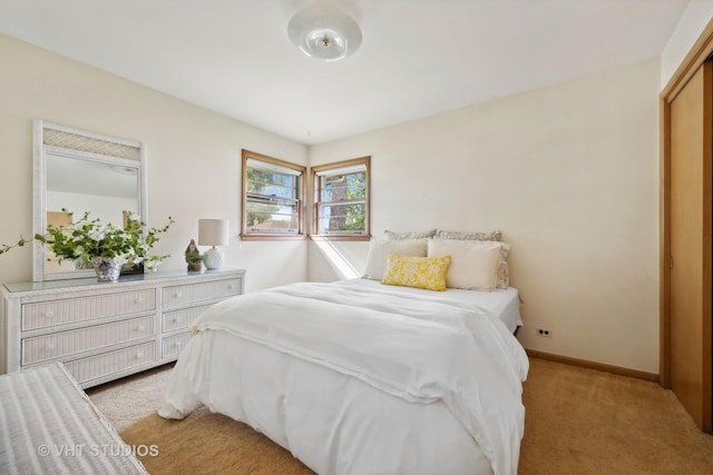 bedroom featuring baseboards and light colored carpet