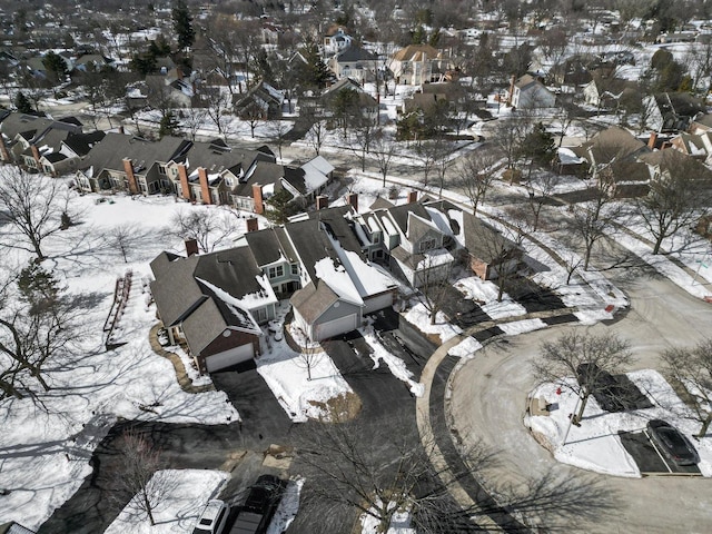 snowy aerial view with a residential view