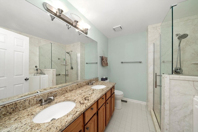 full bathroom with toilet, a stall shower, baseboards, and a sink