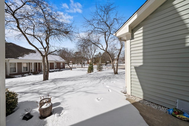 view of yard layered in snow