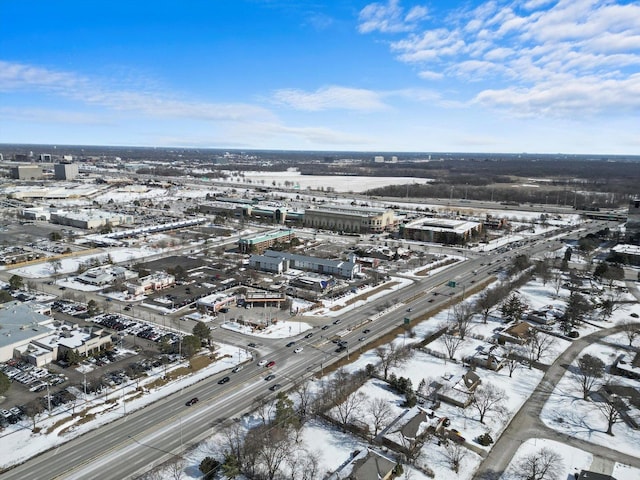 snowy aerial view with a city view