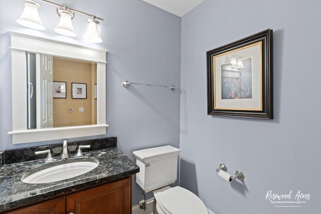 bathroom featuring toilet and vanity