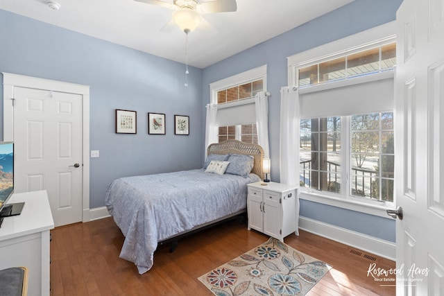 bedroom featuring visible vents, baseboards, ceiling fan, and dark wood-style flooring