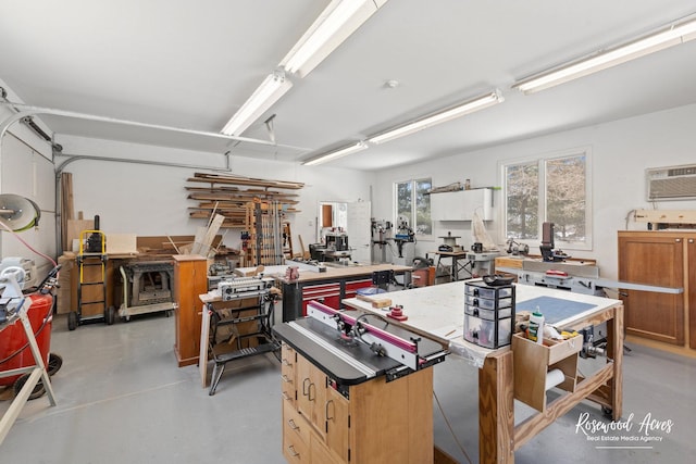 garage featuring a workshop area and a wall mounted AC