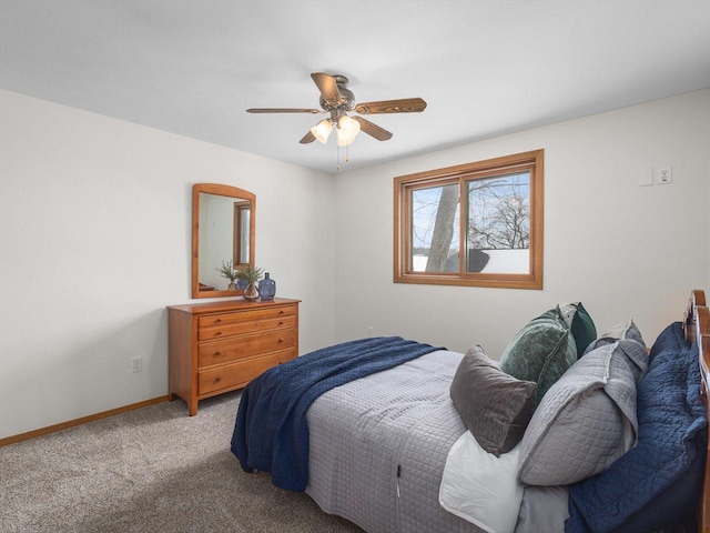 carpeted bedroom featuring baseboards and a ceiling fan